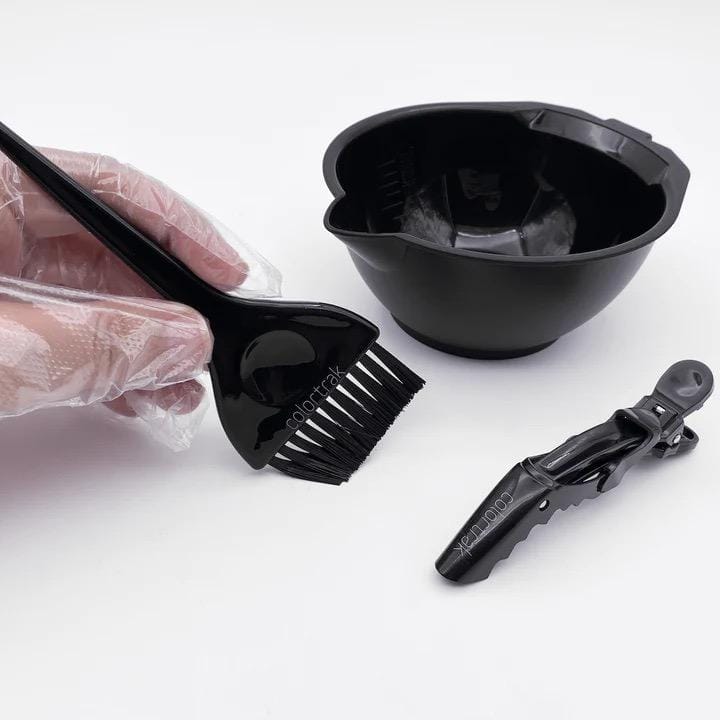 A hair coloring kit including a black brush comb, a black mixing bowl, and a hair clip, displayed on a white background.