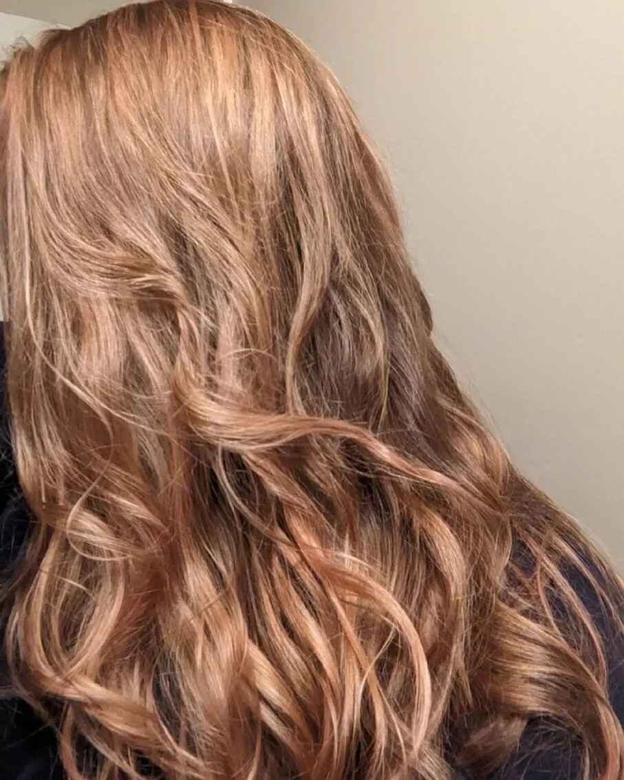 Close-up of wavy hair with champagne beige high lift hair color