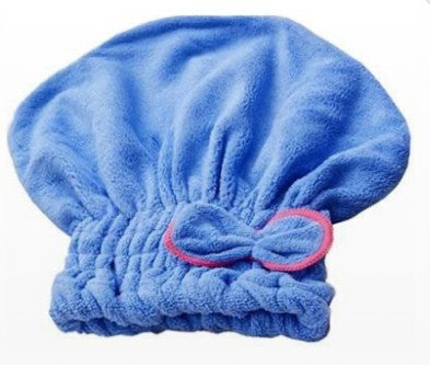 A blue microfiber hair towel with a pink bow detail, designed for absorbing water and minimizing dripping.